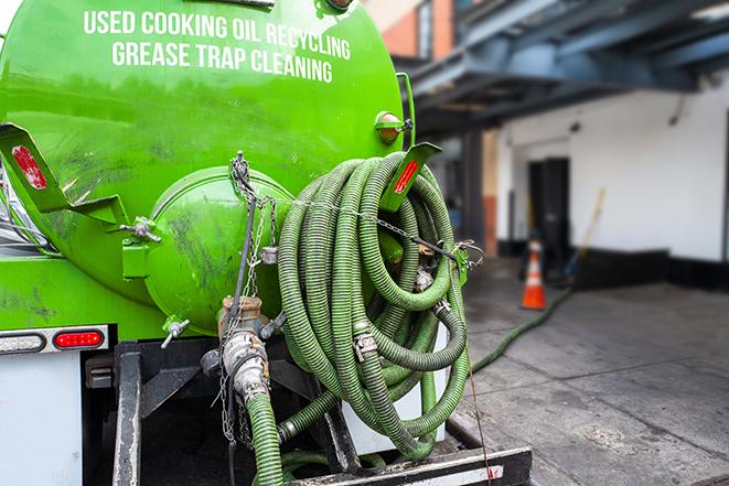 a professional technician pumping a restaurant's grease trap in East Bangor